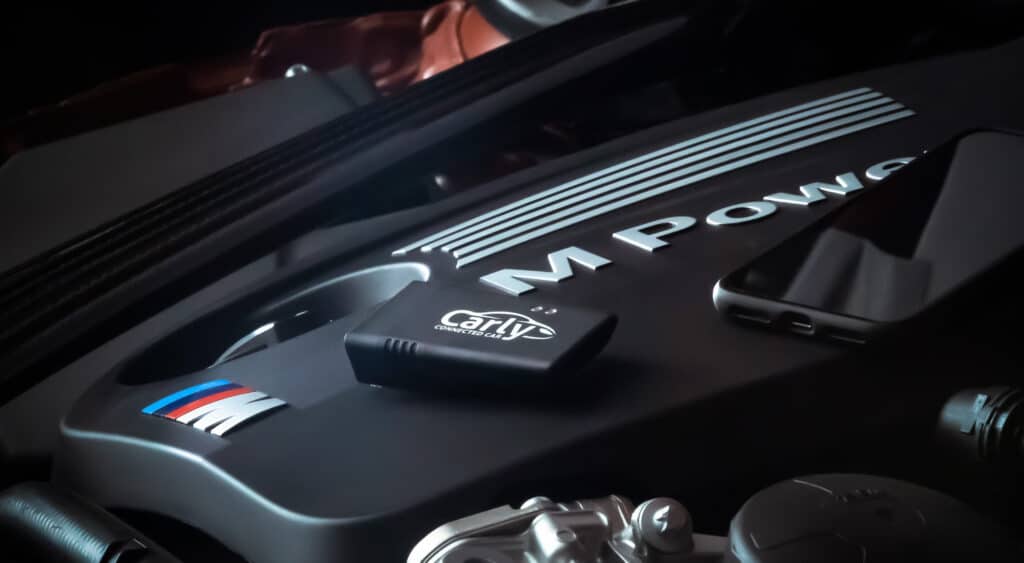 A mechanic using an OBD2 scanner to diagnose a car