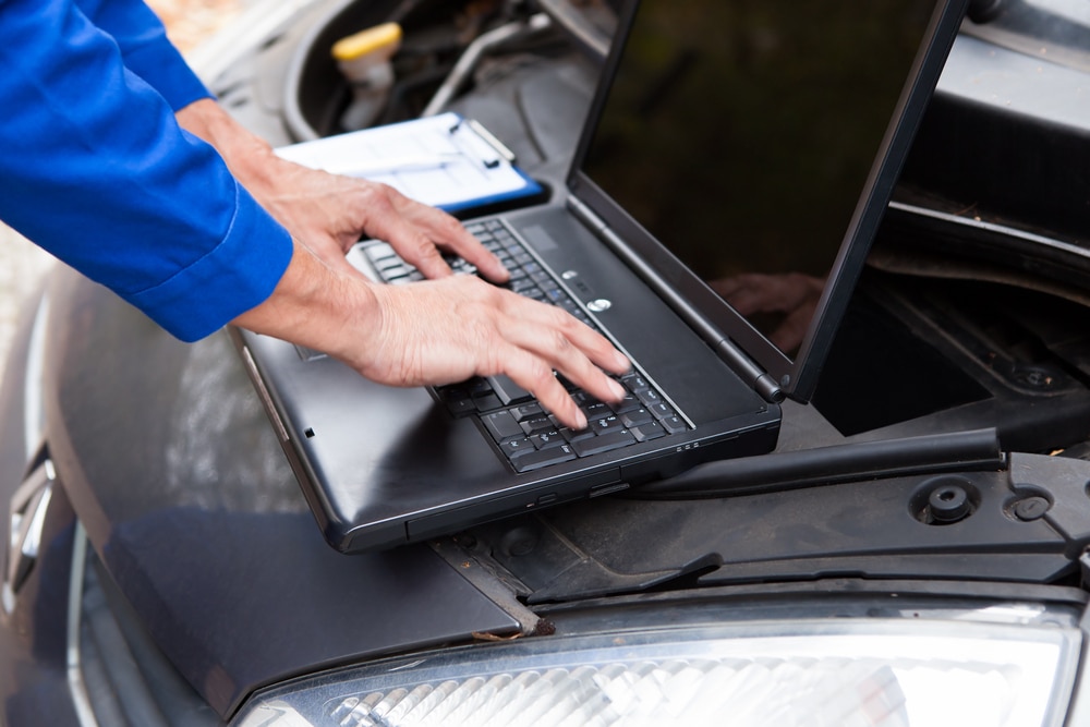 A mechanic using a scan tool to diagnose a car