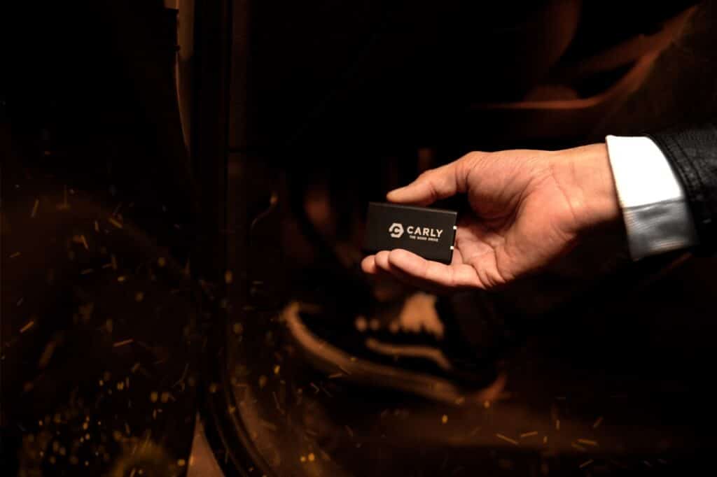 A man using a code reader to read codes from a car